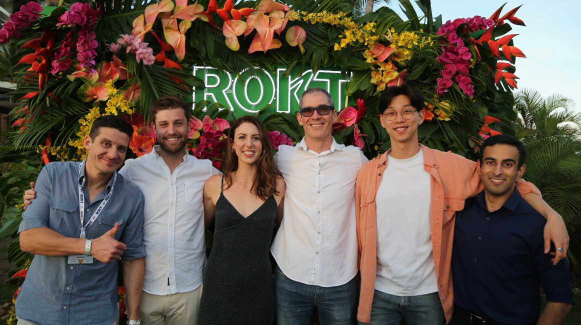 A group of Rokt'stars at an event, smiling and posing for a photograph